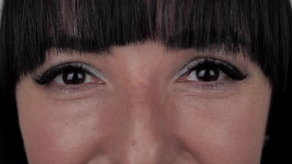 Brown Female Eyes Looking Straight and Smiling