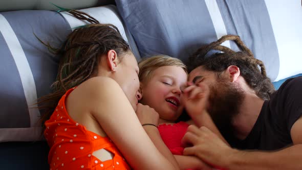 Happy Family Resting on the Bed