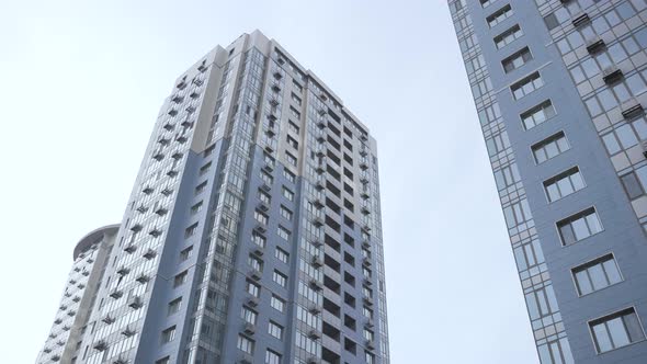 Food Delivery Man Carrying Bike Among Skyscrapers