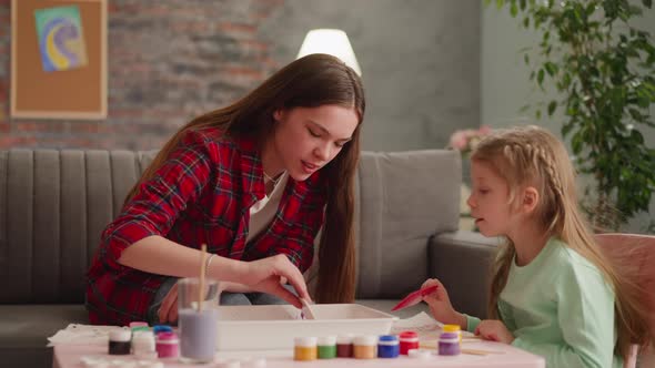 Child Looks at Sister Doing Pattern with Comb for Ebru Art