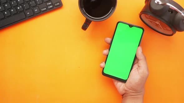 Top View of Man Hand Using Smart Phone on Office Desk