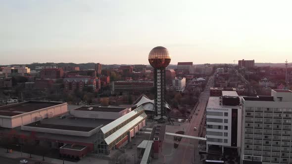 Aerial footage of Sunsphere in downtown Knoxville, Tennessee flying straight forwards over city and