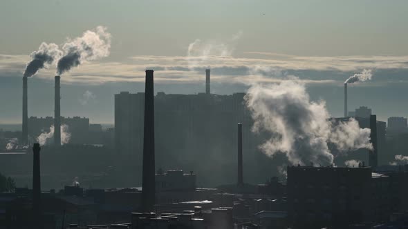 Smoke From Pipes in an Industrial Area of a Large City Silhouetted