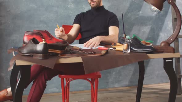 Young Shoemaker Exploring a Painted Boot