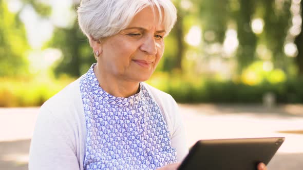 Senior Woman with Tablet Pc at Summer Park 21