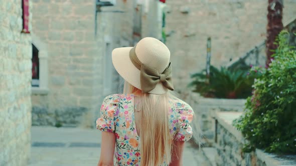 Graceful Woman Walking the Streets of a Medieval City