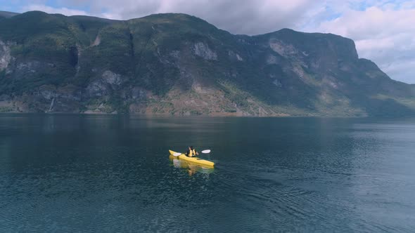 Aerial Drone Shot of Yellow Kayak in Fjord Water