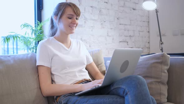 Online Video Chat on Laptop by Casual Woman