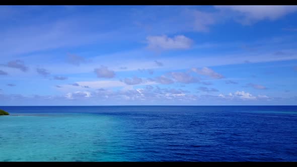 Aerial above panorama of perfect island beach vacation by clear ocean with white sandy background of