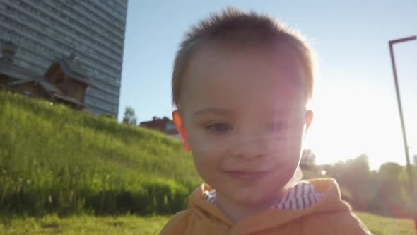 Happy Active Toddler Boy Walking Outdoors in Spring