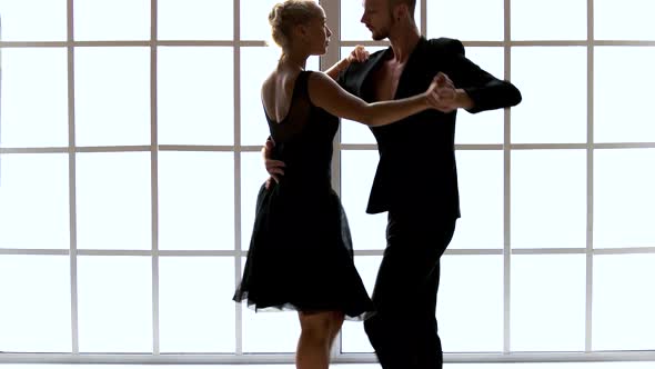 Couple in Black Costumes Dancing Contemporary Dance