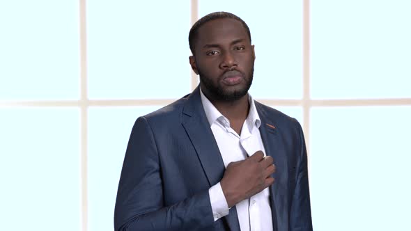 Confident Black Businessman Adjusting His Shirt.