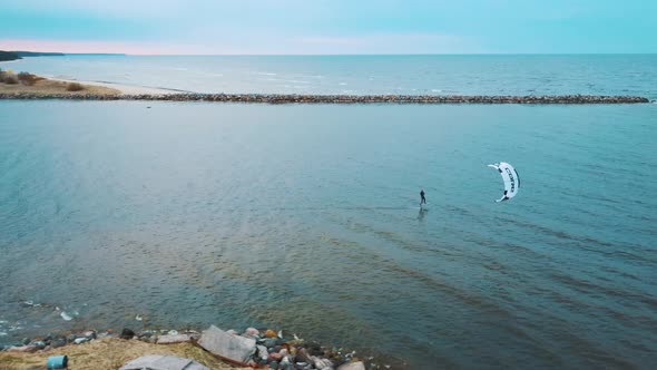 Aerial Drone View of a Corekites Kitesurfers Hydrofoiling  in Engure Port at in Baltic Sea