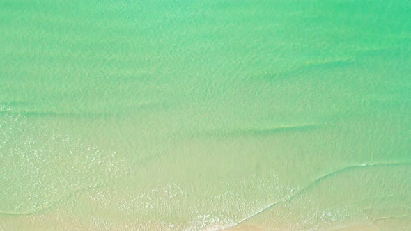 4K Aerial view top view of drone, sea waves and beautiful sand beach.