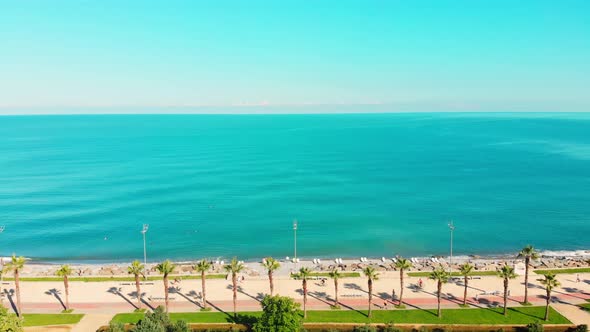 Turquoise Black Sea Water And Tourist On Beach