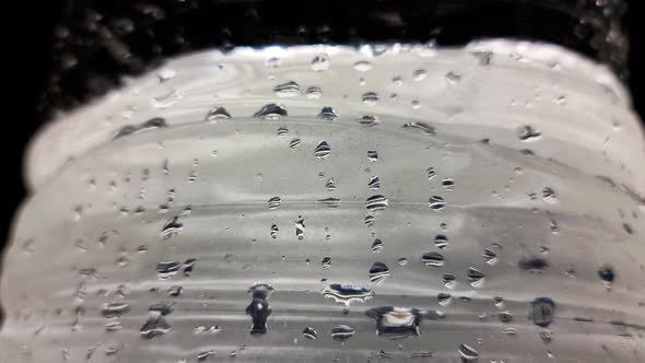 Water in a plastic container. A bottle of water. Water droplets. Wet.