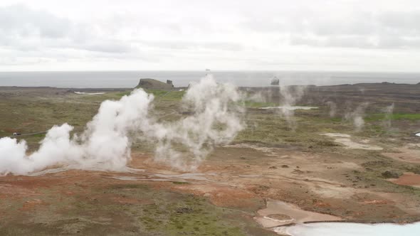 Geothermal Area With Boiling Mud Pools And Steaming Fumaroles In Iceland - aerial drone shot