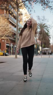 Carefree Woman Walking Along Street