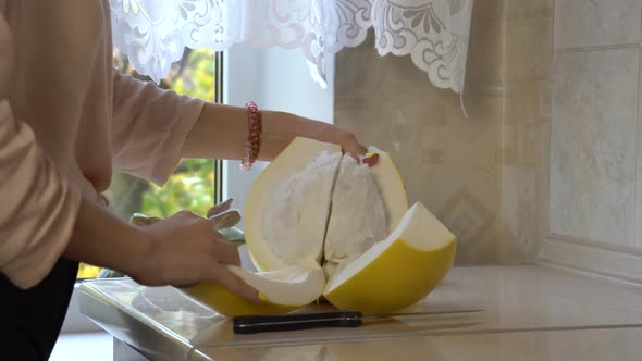 Girl Hands Cleans Pomelo 