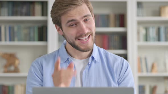 Portrait of Man Talking on Video Call on Laptop