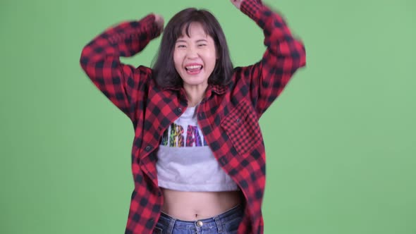 Happy Asian Hipster Woman Getting Good News