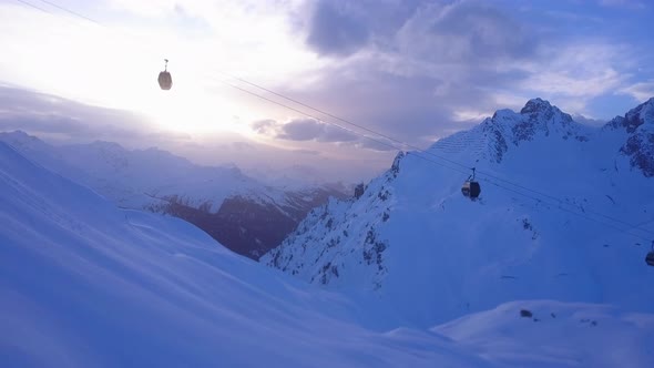 Aerial drone view of a ski gondola lift and mountains at a ski resort