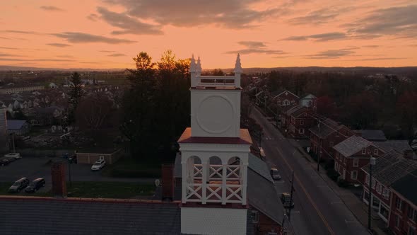 Aerial View of a Small Town and Approaching a Steeple on a Spring Sunrise
