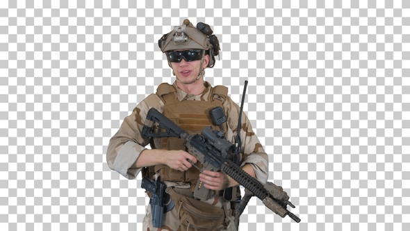 Smiling soldier with assault rifle talking, Alpha Channel