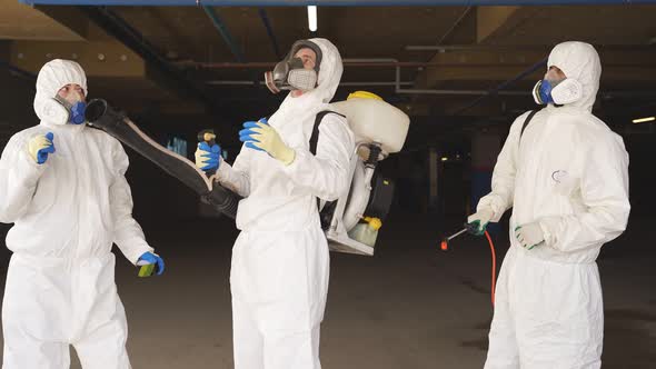 Team of Medical Workers in Hazmat Suits Dancing