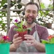 Man Sells Flowers and Seedlings Via Video Link on a Laptop Via the Internet - VideoHive Item for Sale