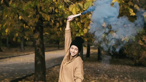 Portrait of Smart Girl Poses in Park and Using Colourful Fires