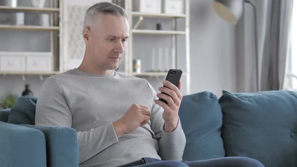 Astonished Gray Hair Man in Shock While Using Smartphone