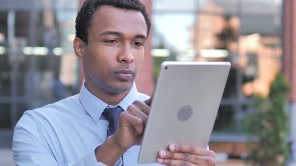 African Businessman Using Tablet Outdoor