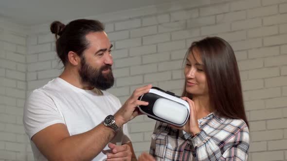 Cheerful Handsome Mature Man Smiling To the Camera, His Friend Using Vr Glasses