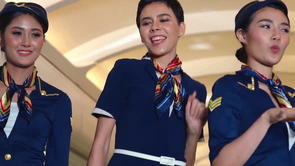 Cabin Crew Dancing with Joy in Airplane