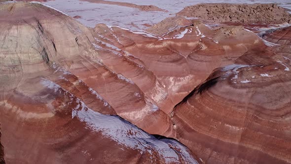 Aerial view looking down at color layers of desert terrain in Utah