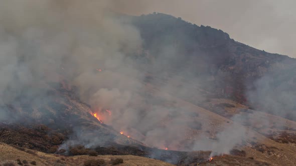 Fire burning in the Utah wilderness up mountain