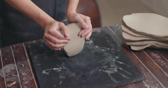 Female Sculptor Kneads Clay with Her Hands to Create Ceramics in Her Workshop