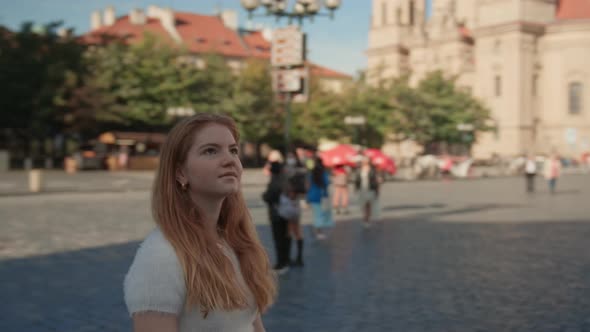 Young Woman Walking In Square In Prague