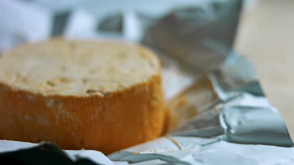 Closeup of Hand Cutting French Cheese Marquis Castello