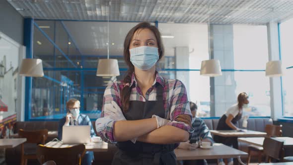 Portrait of Waitress Wearing Face Mask and Gloves While Serving in Coffee Shop