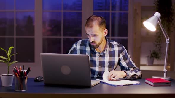 Caucasian Businessman Signing Documents in Home Office