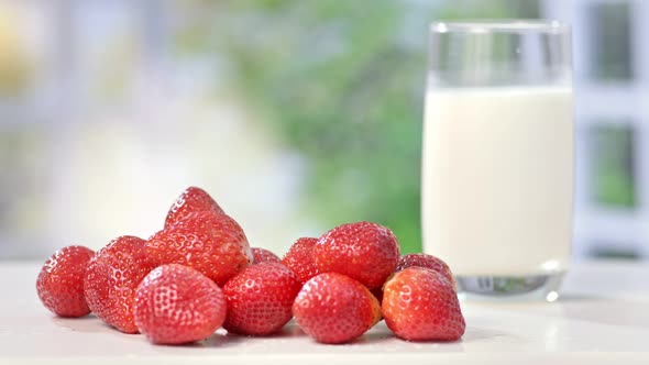 Closeup of Mature Male Hand Putting Fresh Strawberries on Table One By One in Summer Background