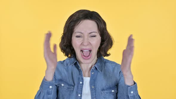 Screaming, Old Woman Shouting on Yellow Background 