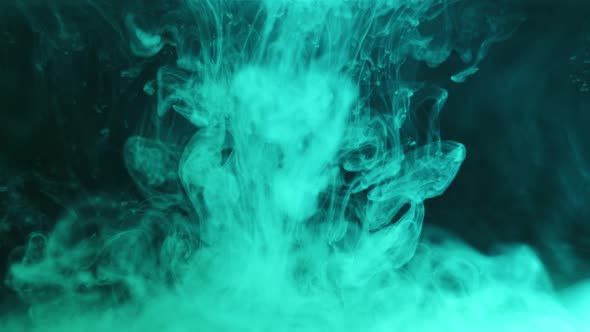 Abstract Shot of White Ink Suspended Into Water on Background of Blue Green Hue