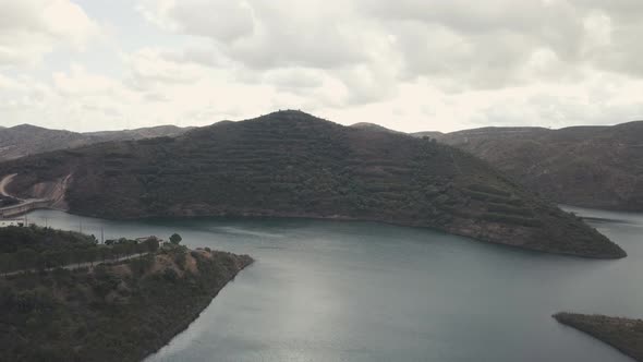Aerial drone shot of natural Lake near Funcho de Diante during mystic cloudscape at sky after sunset