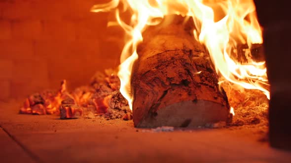 Slow Motion of the Camera on a Slider Frame As in a Pizza Oven, Freshly Baked Firewood Is Burning