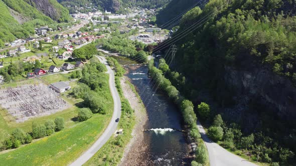 Dale salmon river with Dalekvam town-centre and BKK hydroelectric powerplant - High voltage power ca