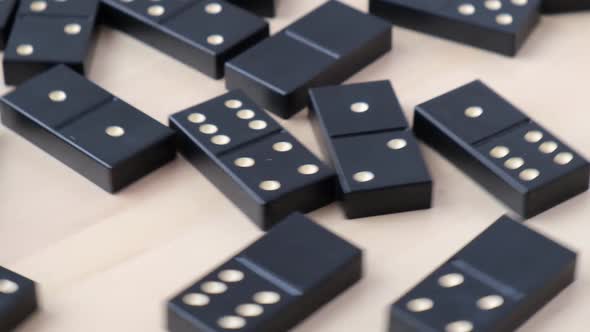 Domino Dice Black with White Dots Rotating Around on Wooden Background