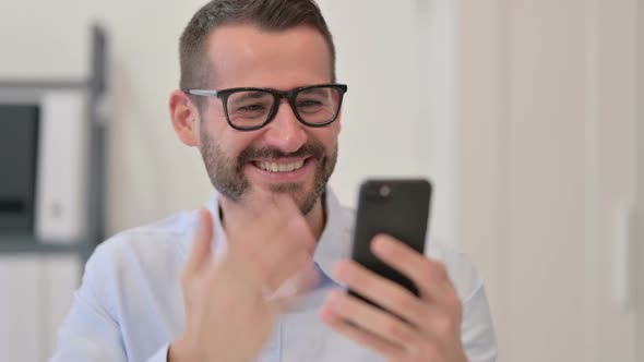 Portrait of Middle Aged Man Excited By Success on Smartphone